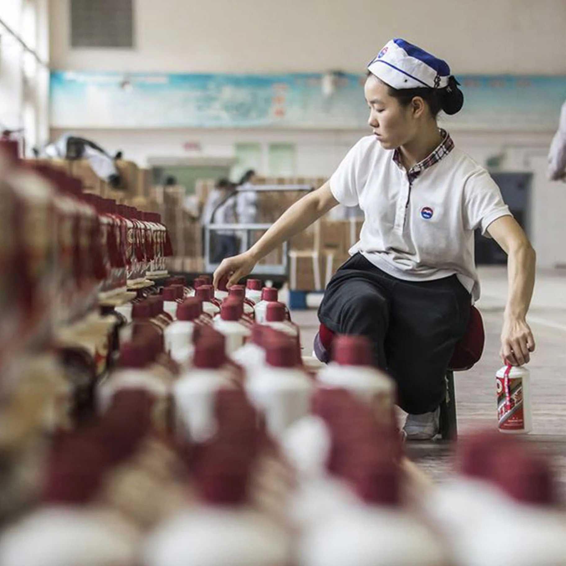 Load image into Gallery viewer, Woman working at a production line in an industrial setting