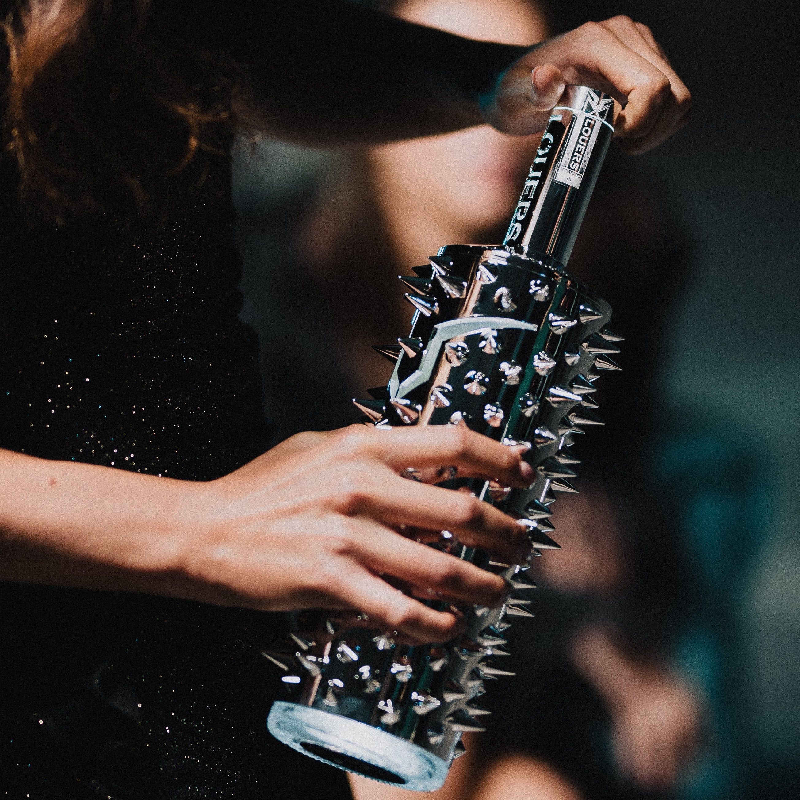 Load image into Gallery viewer, An image of a woman holding a LOUERS vodka in bar or nightclub setting