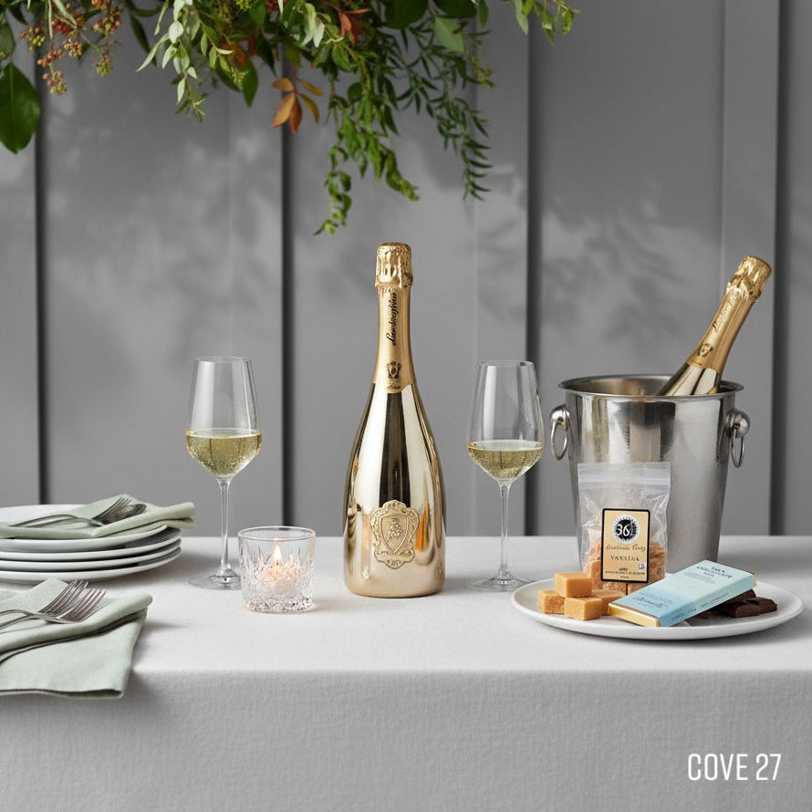 Load image into Gallery viewer, Table setting with LAMBORGHINI SOUMANTE bottles, glasses, and snacks on a gray tablecloth.