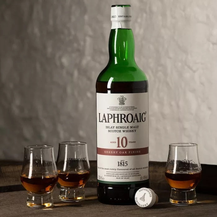 Load image into Gallery viewer, A bottle of Laphroaig 10YO Sherry Oak Finish Whisky with three full glasses of whisky