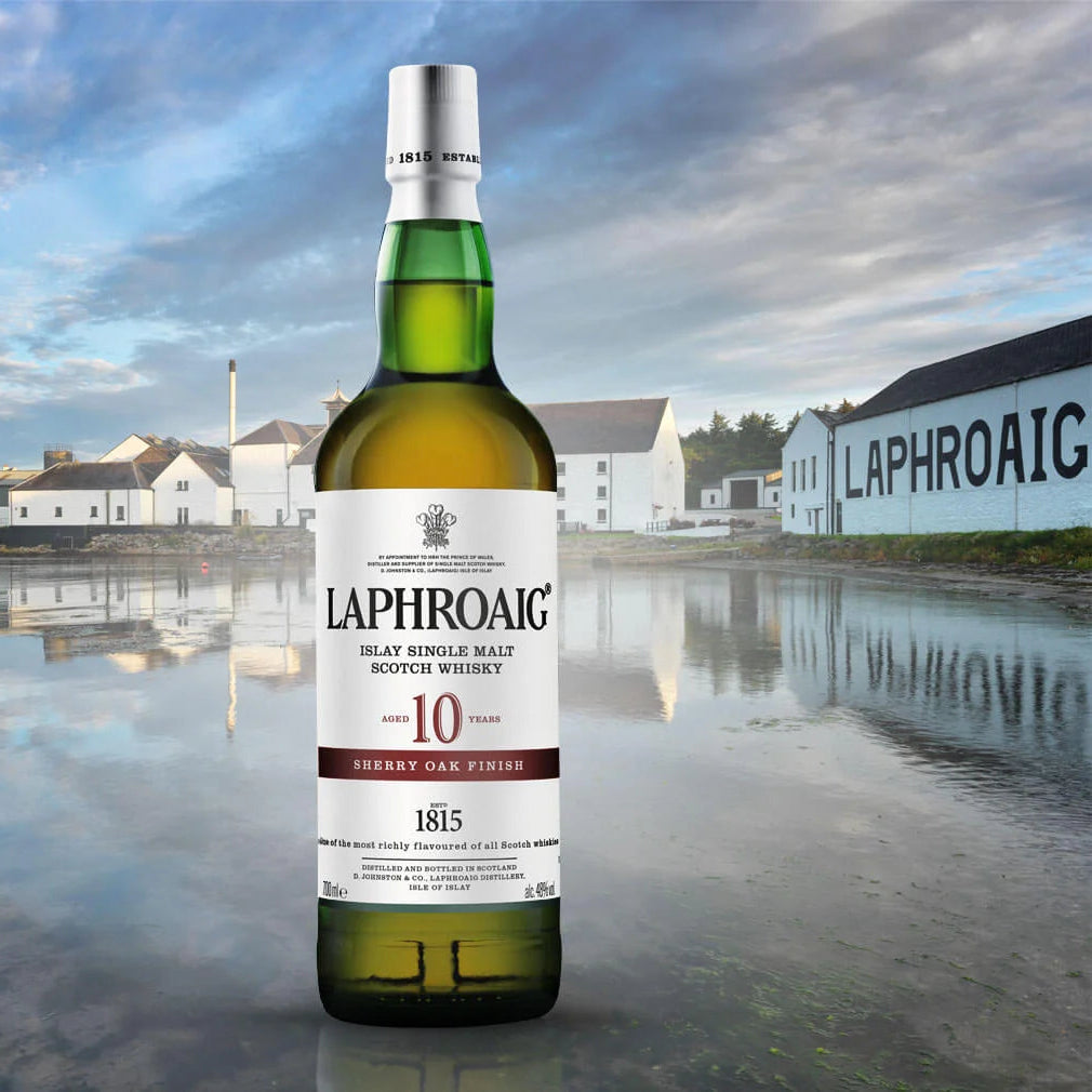 Laphroaig whisky bottle with a scenic background featuring a distillery.