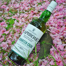 Load image into Gallery viewer, Laphroaig Quarter Cask whisky bottle on pink flower petals