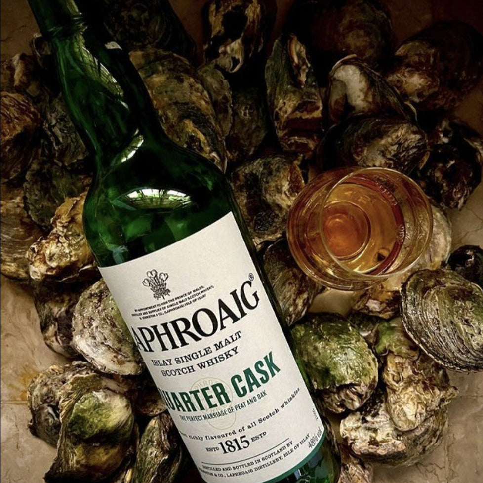 Bottle of Laphroaig-Quarter-Cask-Scotch-Whisky surrounded by oysters