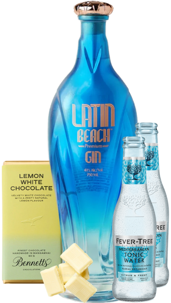 A blue glass bottle of Latin Beach Gin stands centrally on a white background, flanked by two Fever Tree tonic water bottles and a yellow box of Lemon White Chocolate. Cubed milk chocolate pieces are placed in front of the gin bottle.