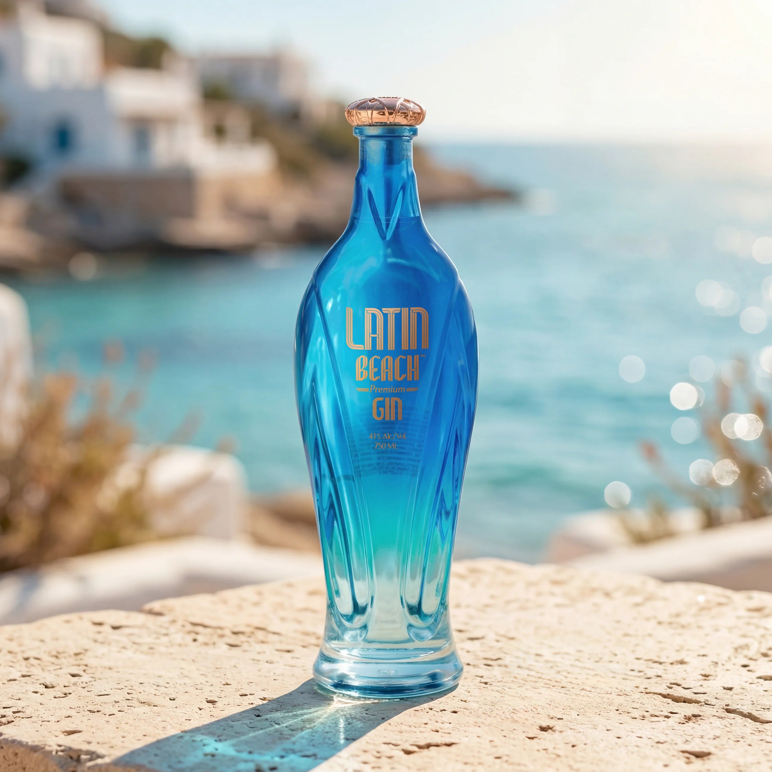 Load image into Gallery viewer, Blue bottle of Latin Beach Gin on a rock with a Amalfi coastal background