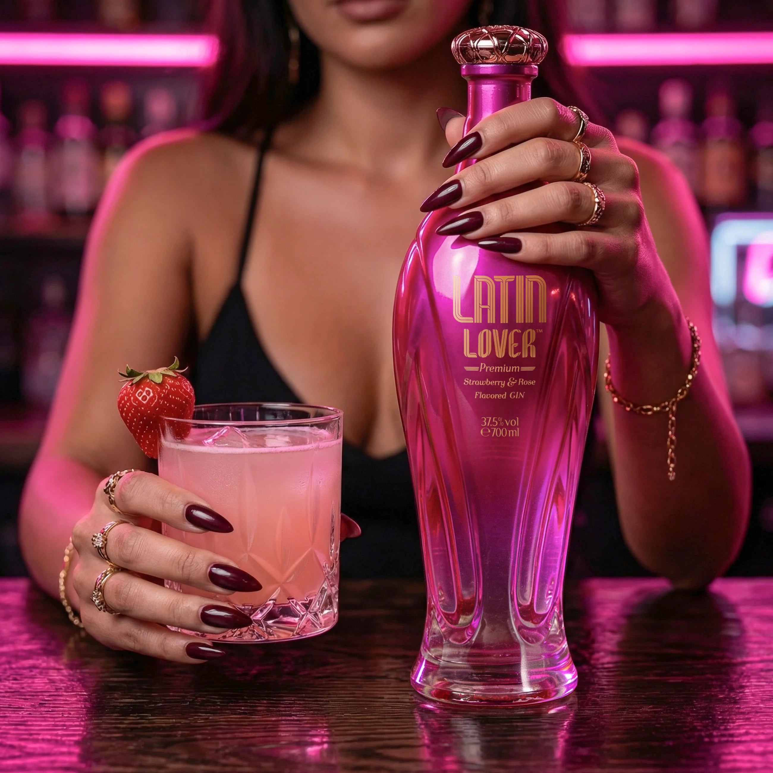 Load image into Gallery viewer, Woman holding a pink Latin Lover Gin bottle and a glass of pink cocktail with a strawberry garnish.