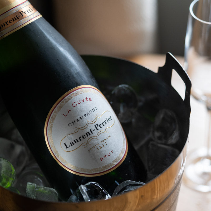 Load image into Gallery viewer, Bottle of Laurent-Perrier champagne in an ice bucket with a blurred background