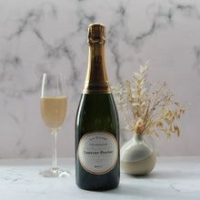 Load image into Gallery viewer, Laurent-Perrier champagne bottle with a glass of champagne on a marble surface.