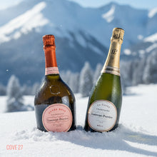 Load image into Gallery viewer, Two Laurent-Perrier champagne bottles in the snow with mountains in the background