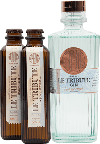 An image of a bottle of Le Tribute Gin next to two bottles of Le Tribute Tonic Waters