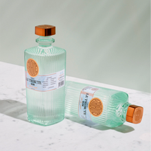 Load image into Gallery viewer, Two bottles of Le Tribute Gin on a white marble surface