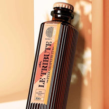 Load image into Gallery viewer, Bottle of Le Tribute Pink Grapefruit Tonic Water on a beige background