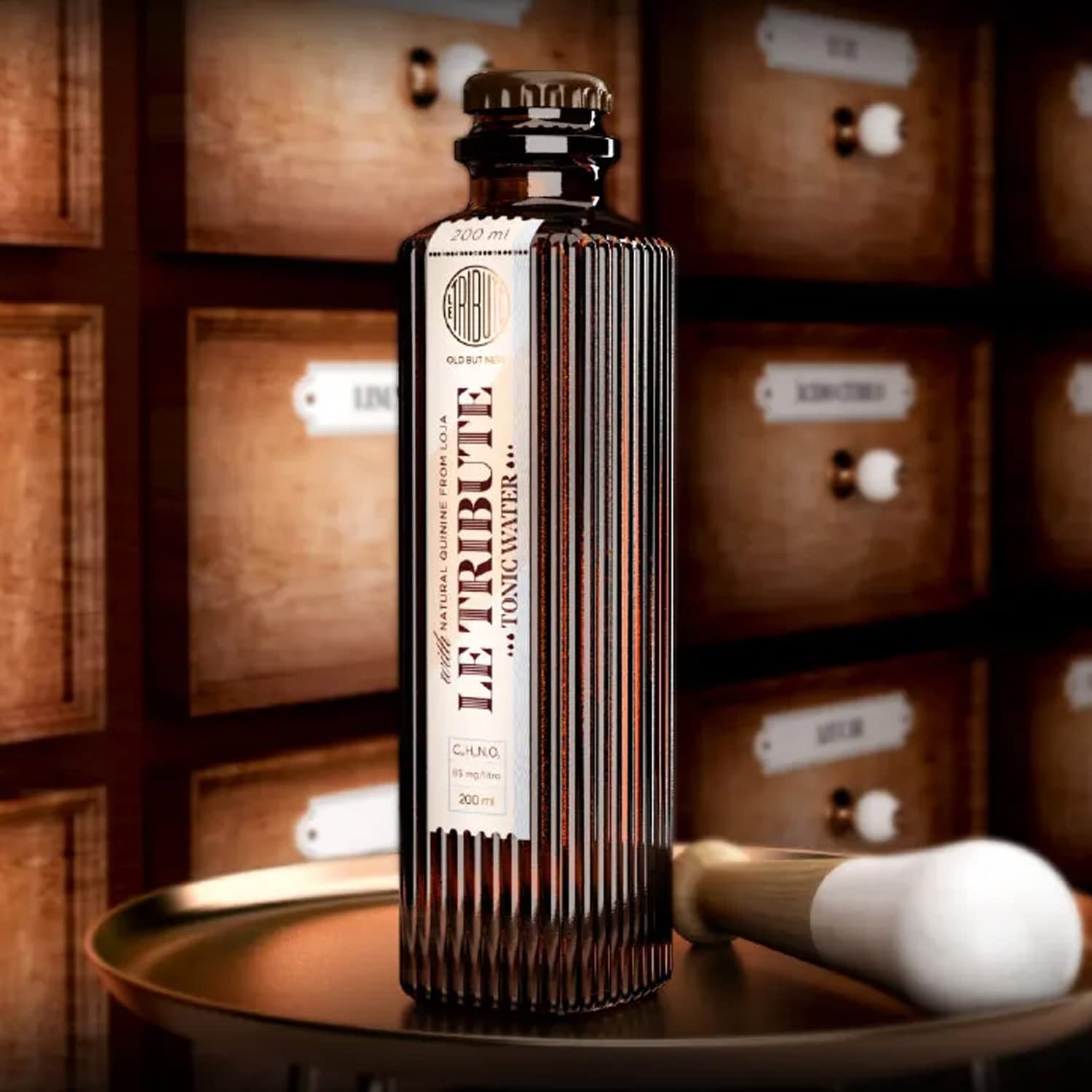 Load image into Gallery viewer, Bottle of Le Tribute Tonic Water on a wooden barrel with wooden cabinets in the background