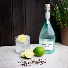 Load image into Gallery viewer, An image of a stunning and award-winning bottle of Lind &amp; Lime London Dry Gin from Leith in Scotland, standing next to a delicious gin and tonic cocktail