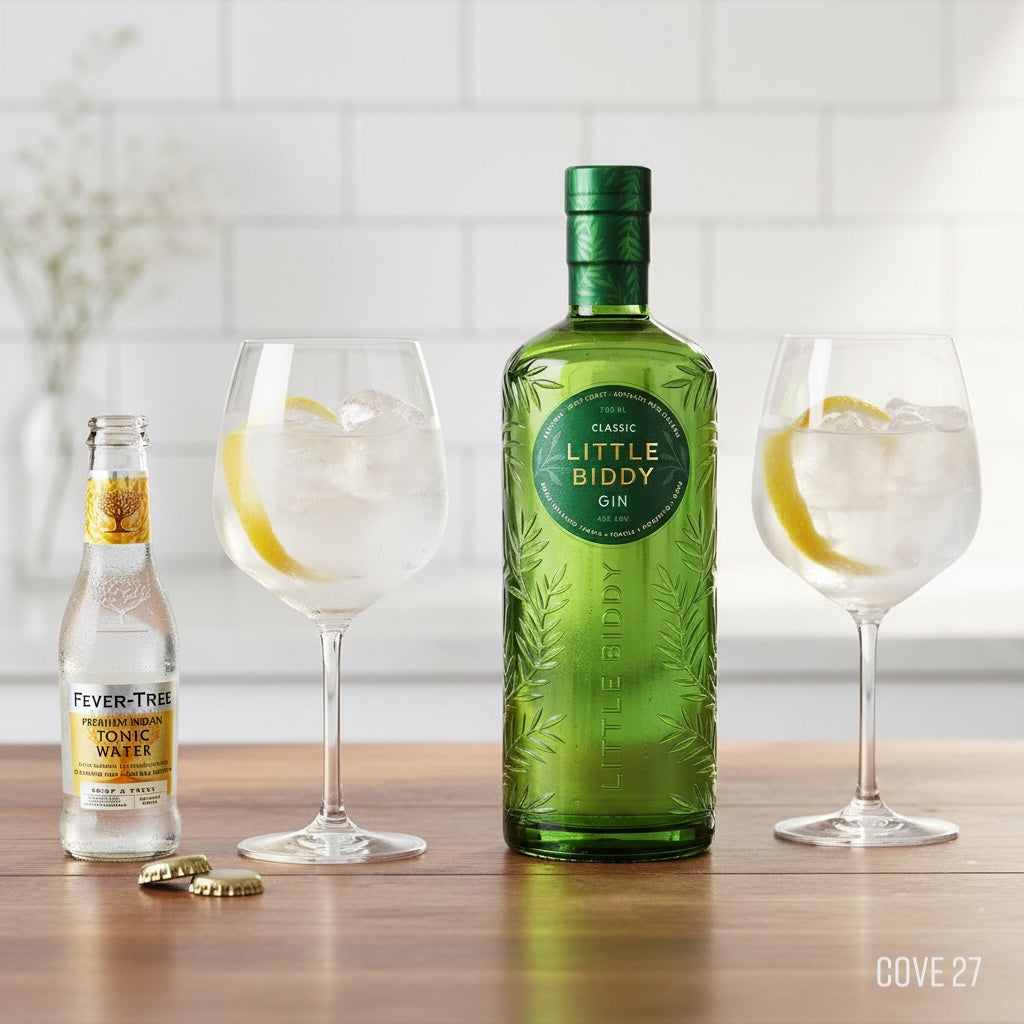 Load image into Gallery viewer, Green bottle of Little Biddy Gin with two glasses and a bottle of Fever-Tree tonic water on a wooden surface.