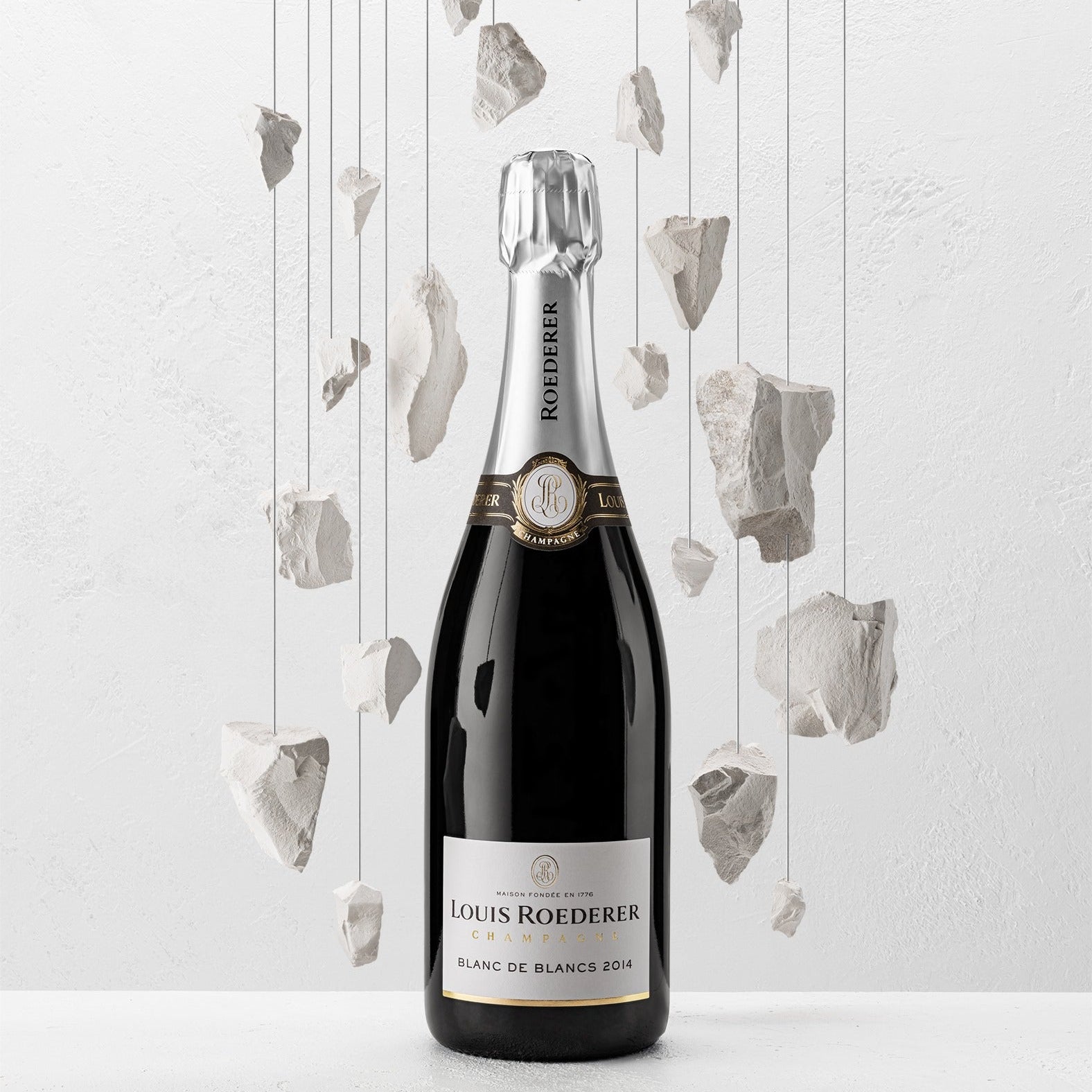 Load image into Gallery viewer, Louis Roederer champagne bottle with decorative elements on a light background