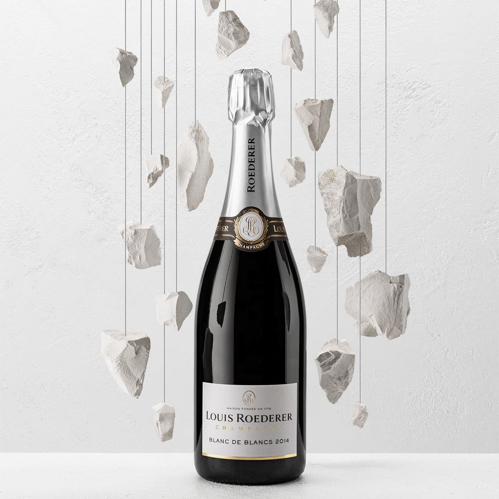 Louis Roederer champagne bottle with decorative elements on a light background
