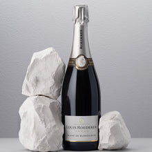 Load image into Gallery viewer, Louis Roederer champagne bottle with decorative rocks on a gray background