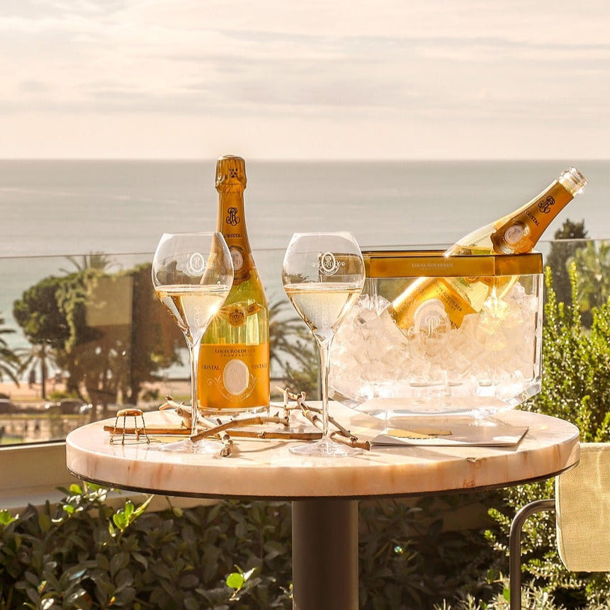 Load image into Gallery viewer, Table with champagne and glasses on a balcony with ocean view