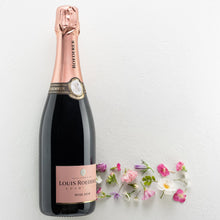 Load image into Gallery viewer, Bottle of Louis Roederer rosé champagne with flowers on a light background