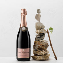 Load image into Gallery viewer, Louis Roederer rosé champagne bottle with a stone sculpture on a white background
