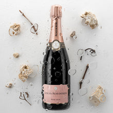 Load image into Gallery viewer, Louis Roederer rosé champagne bottle with decorative elements on a light background