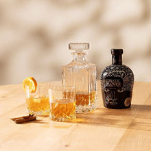 Load image into Gallery viewer, Bottle of Lunatic-Lover-Silver-Rum with glasses on a wooden table