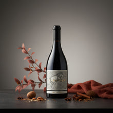 Load image into Gallery viewer, A bottle of MITOLO-MARSICAN-SHIRAZ  bottle with decorative elements on a dark surface