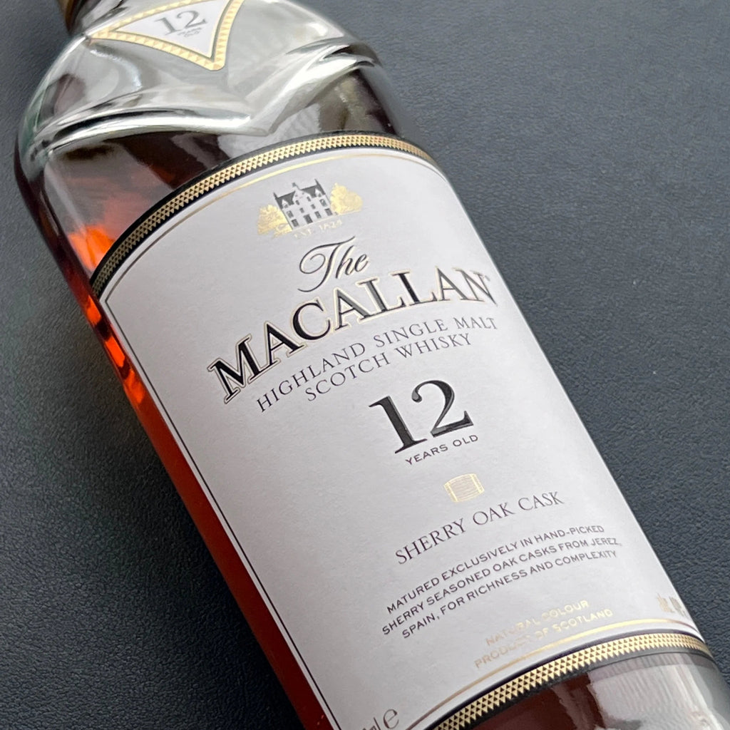 Macallan 12 YEAR OLD SHERRY CASK whisky bottle with label on a dark background