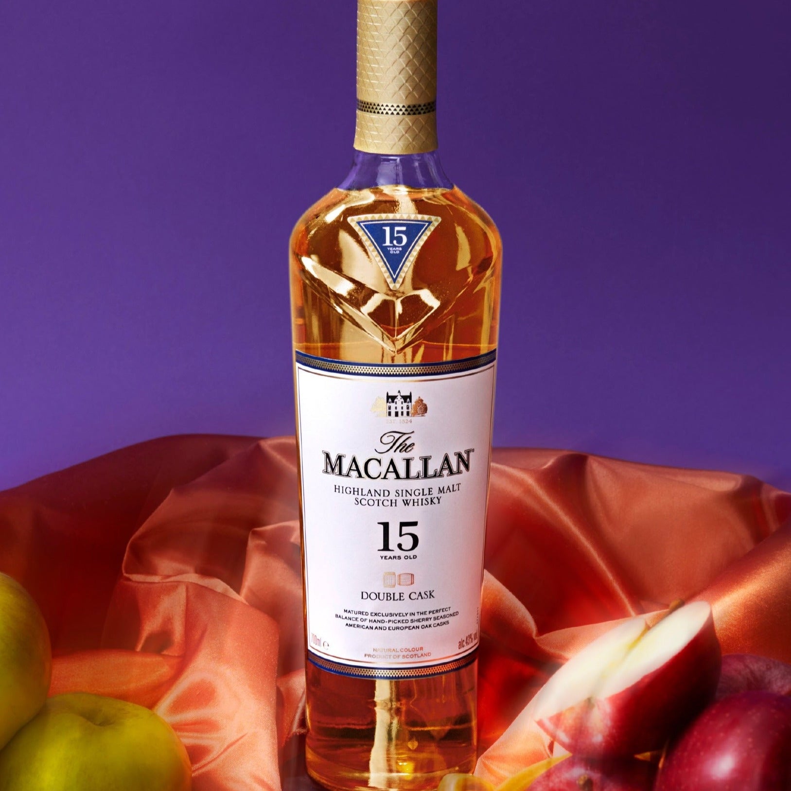Load image into Gallery viewer, Macallan 15 year old whisky bottle with apples on a purple background