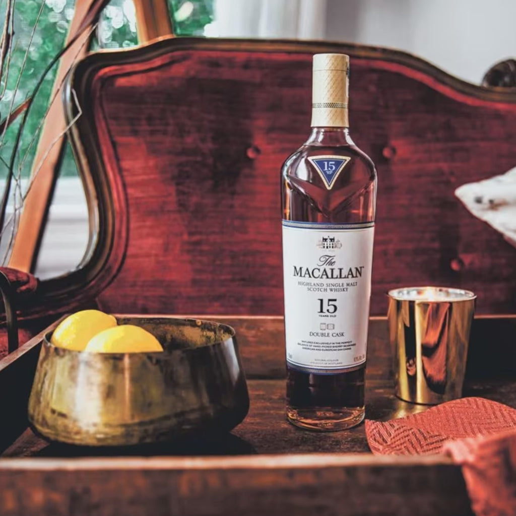 Macallan 15 year old whiskey bottle on a wooden table with decorative elements