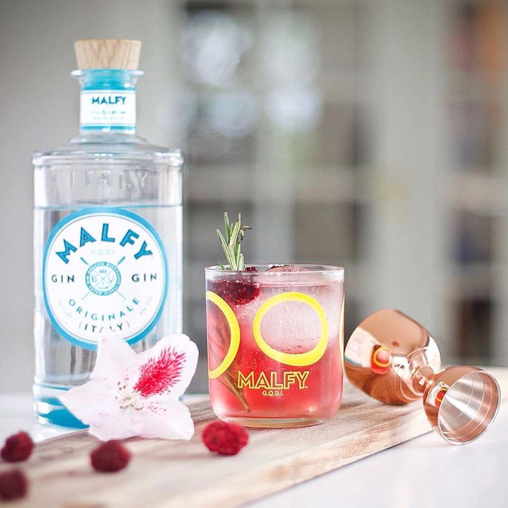 Load image into Gallery viewer, Bottle of Malfly gin with a cocktail and garnishes on a wooden board.