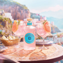 Load image into Gallery viewer, A lifestyle image of a delicious bottle of Malfy Rosa Pink Mediterranean Gin surrounded by mouthwatering cocktails