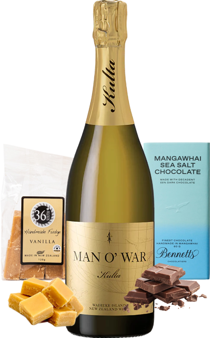 Load image into Gallery viewer, A Man O’ War Kulta Tulia Blanc de Blanc sparkling wine bottle centred on a white background, surrounded by gift items including a bag of 36 Degrees vanilla handcrafted fudge, a box of Bennett's Mangawhai sea salt chocolate, and pieces of vanilla fudge and dark chocolate.