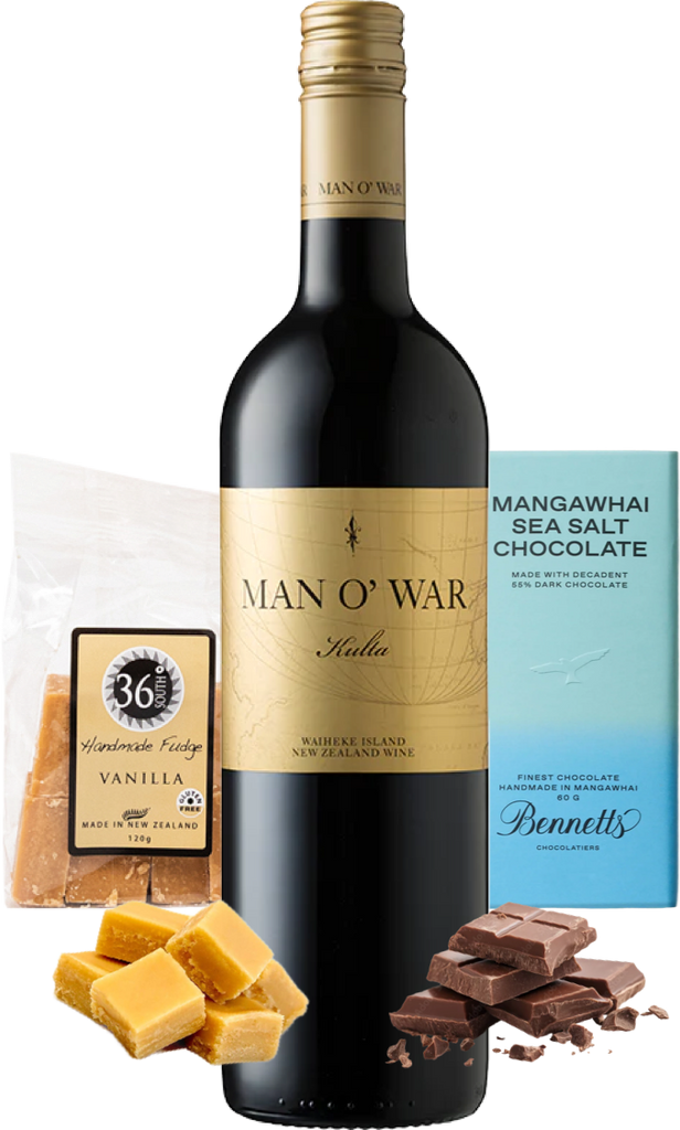 A bottle of Man O' War Kulta 'Tytti' Bordeaux Blend red wine centred on a white background, surrounded by product props including a bag of 36 Degrees Vanilla Handmade Fudge, a blue Bennett's Mangawhai Sea Salt Chocolate bar, and vanilla fudge and chocolate pieces.