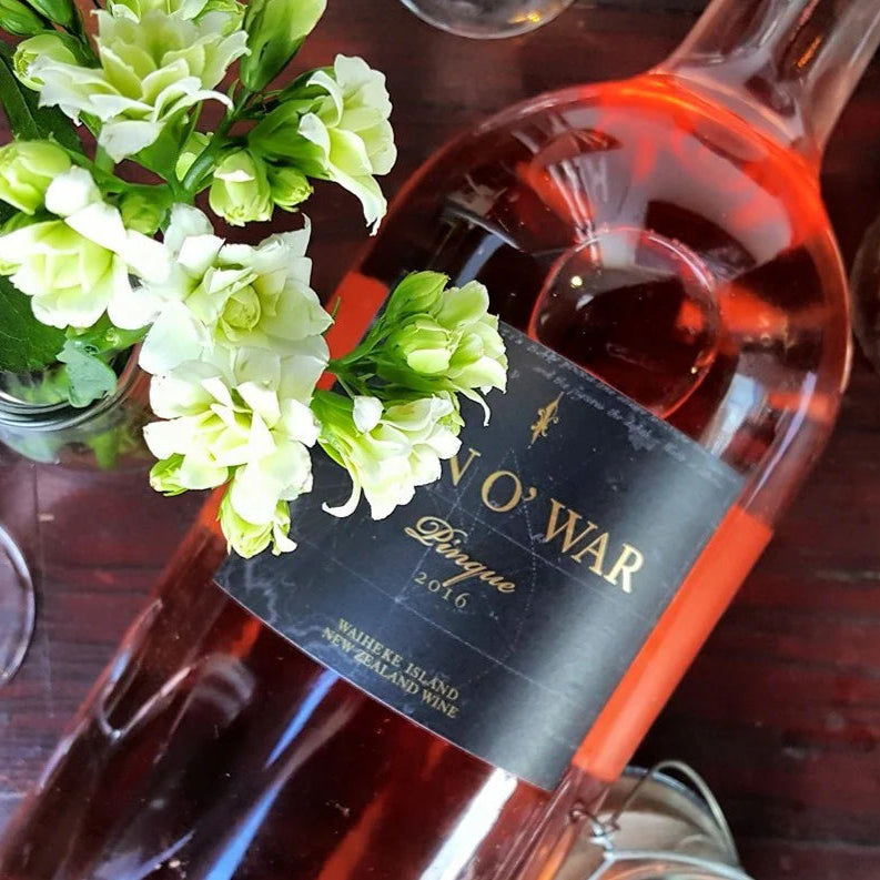 Load image into Gallery viewer, A bottle of Man O' War Rosé on a wooden table with some white flowers