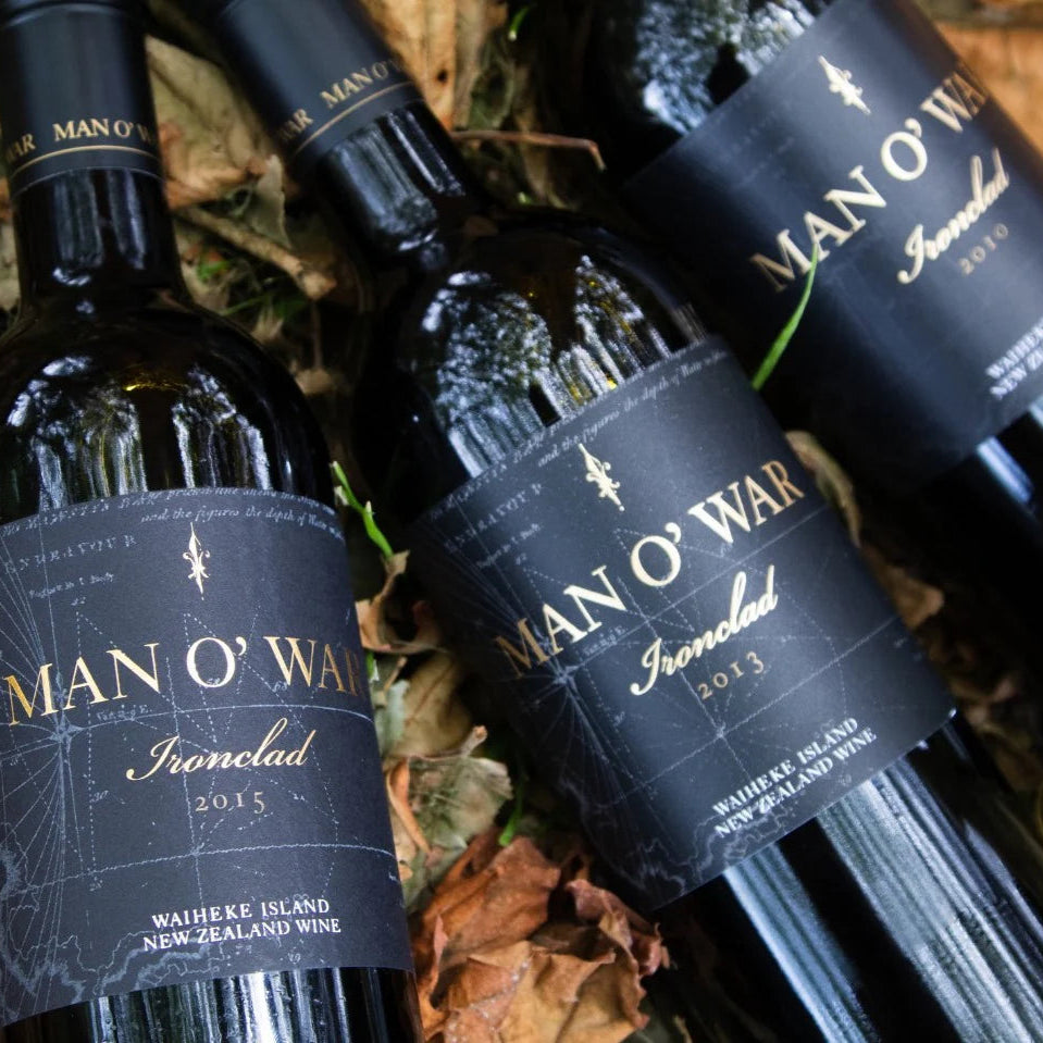 Load image into Gallery viewer, Bottles of Man O' War Ironclad Bordeaux Blend wine with labels on a leafy background