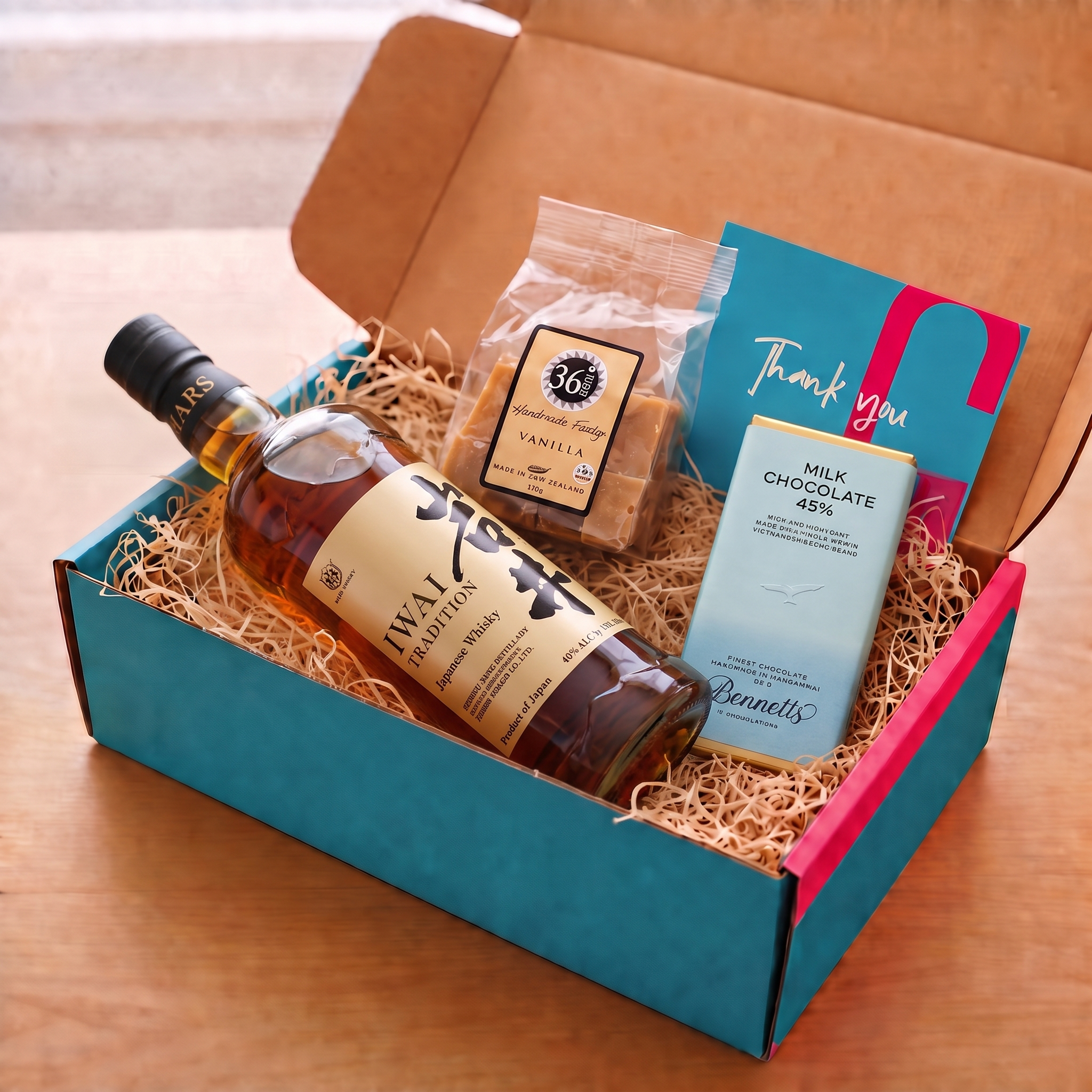 Load image into Gallery viewer, A COVE 27 GIFT BOX INCLUDING A BOTTLE OF Mars Iwai Tradition Whisky, A PACKET OF 36 DEGREES vanilla fudge AND A BAR OF BENETT'S MILK chocolate.