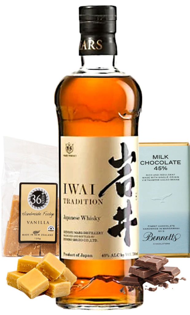 A bottle of Mars Iwai Tradition Japanese Whisky is centred on a white background, flanked by a bag of 36 Degrees Vanilla Handmade Fudge, a box of Bennett's Milk Chocolate 45%, and chocolate pieces and vanilla fudge squares.