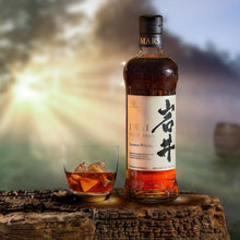 Load image into Gallery viewer, Bottle of Mars Iwai whisky with a glass of whisky on a wooden surface, blurred background