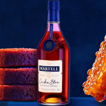 Load image into Gallery viewer, A bottle of Martell Cordon Bleu Cognac  with some cakes and honey on a blue background