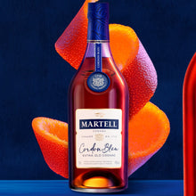 Load image into Gallery viewer, A bottle of Martell Cordon Bleu Cognac  with a large orange peel on a blue background