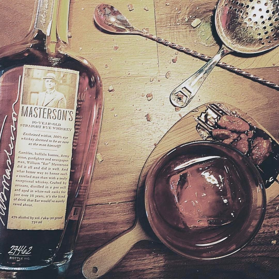Load image into Gallery viewer, Masterson's 10 Year Old Straight Rye whiskey bottle with a glass of whiskey on a wooden surface