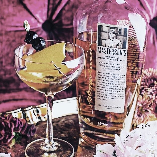 Load image into Gallery viewer, Bottle of Masterson's 10 Year Old Straight Rye whiskey with a cocktail glass containing a drink and garnish.