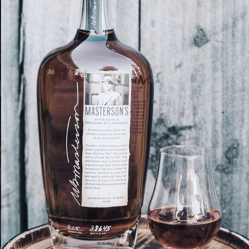 Load image into Gallery viewer, Masterson's 10 Year Old Straight Rye whiskey bottle with a glass of whiskey on a wooden surface
