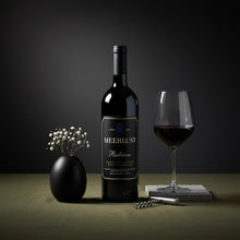 Load image into Gallery viewer, Meerlust Estate Rubicon red wine bottle with a glass of red wine on a dark background
