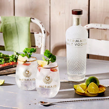 Load image into Gallery viewer, Mermaid Salt Vodka bottle with two glasses and garnishes on a wooden table.