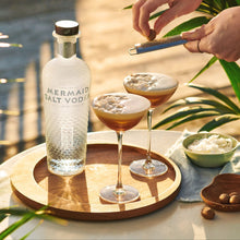 Load image into Gallery viewer, Mermaid Salt Vodka bottle with cocktails on a wooden tray by a poolside.