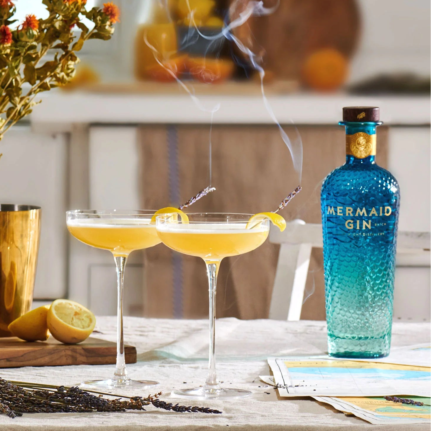 Load image into Gallery viewer, Mermaid Gin bottle with two cocktails on a table with a blurred background
