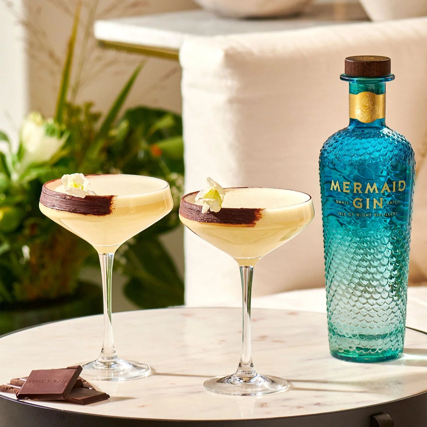 Load image into Gallery viewer, Mermaid Gin bottle with two cocktails on a table outdoors